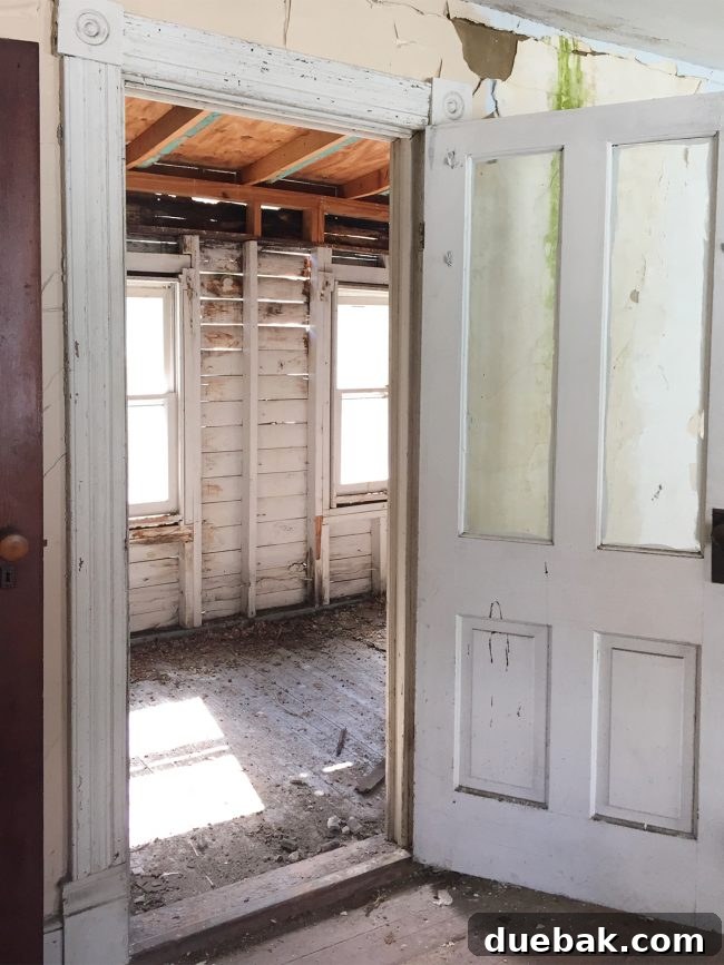 Our Beach House Makeover: Upstairs Edition 14 Damaged bunk room before renovation with light showing through rotten walls