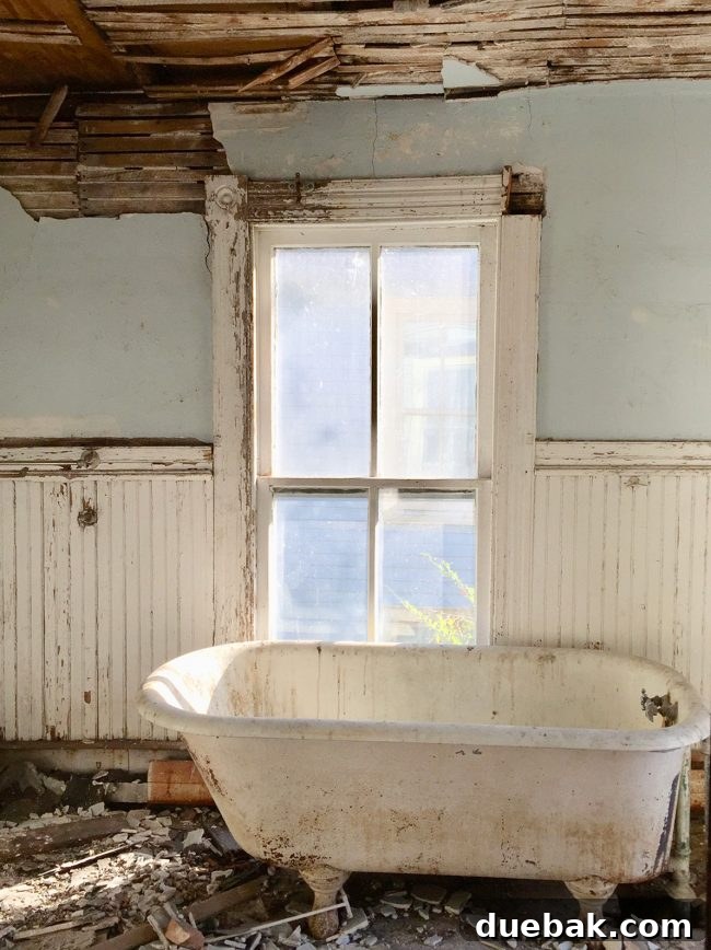 Our Beach House Makeover: Upstairs Edition 26 En-suite bathroom before renovation, showing old tub and layout