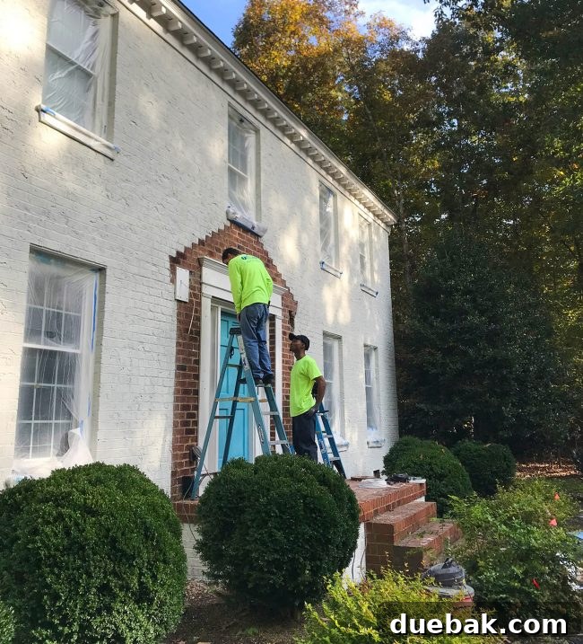The Setbacks That Nearly Sank Our Painted House Makeover 6 Electricians installing new exterior light fixtures on white composite blocks