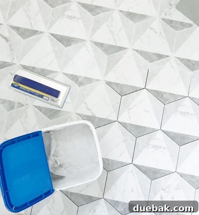 Finished bathroom with marble-look hex tile floor, demonstrating grout consistency.