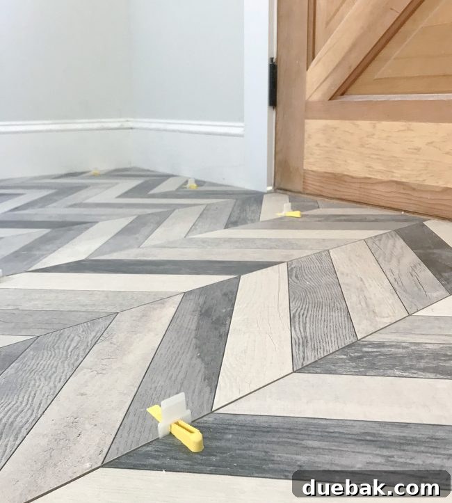 Close-up of chevron mudroom floor tile, showing precise alignment and spacing.