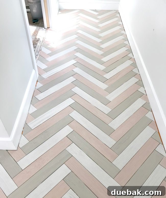Mudroom floor with a complex herringbone pattern made from three different colored tiles.