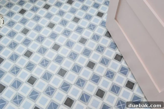 Hall bathroom with 9x9 inch square patterned floor tile and a White Truffle door.