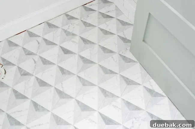Bathroom floor with elegant marble-look hexagonal tiles and an Oyster Bay door.