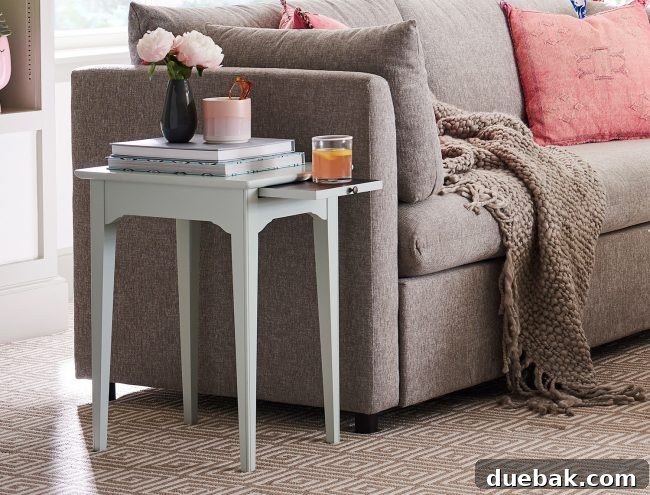 Valet End Table in Blue next to a Mellow Sofa, adding a pop of color and functionality