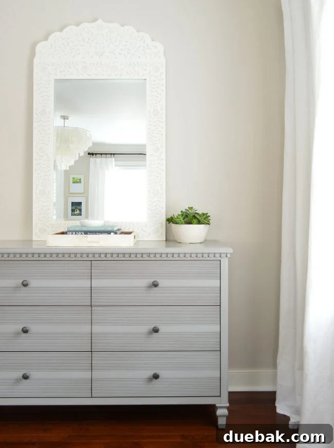 Debonair Dresser in Grey paired with a Stenciled Mirror, creating a sophisticated bedroom vignette