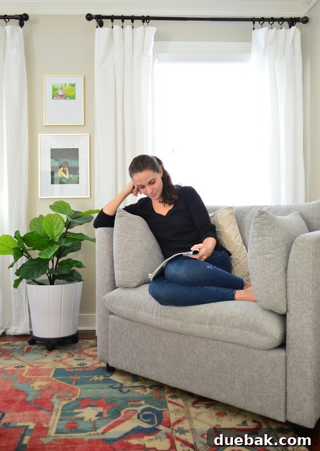 A person comfortably relaxing in a Mellow Armchair, embodying ultimate comfort