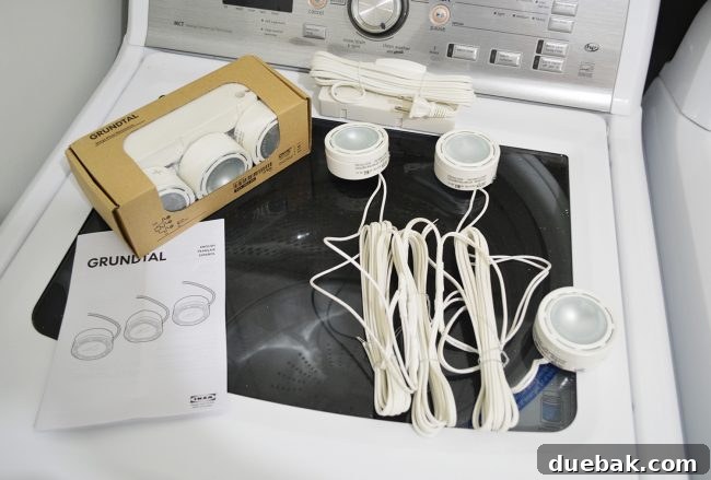 Elevate Your Kitchen Design with Under-Cabinet Lighting 3 Close-up view of the older Ikea GRUNDTAL spotlights before installation, displaying the individual puck lights and their connecting wires.