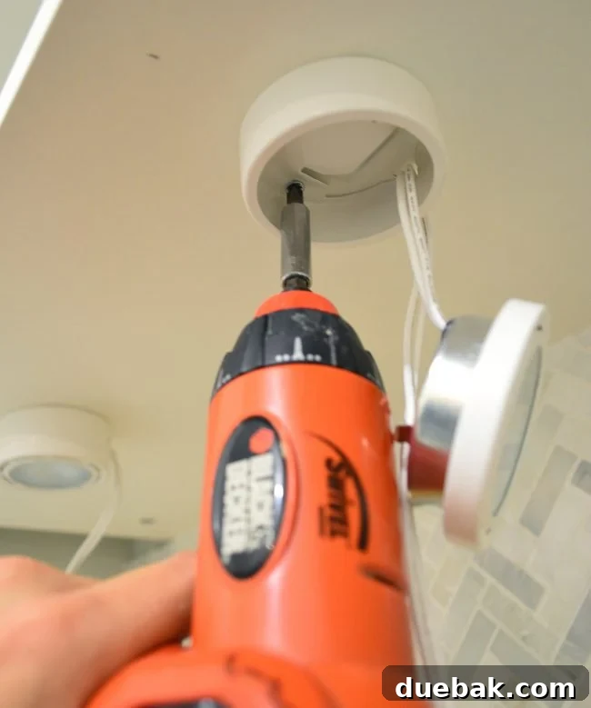 Unlock Your Kitchen's Brilliance 5 Securing under cabinet spotlight to cabinet underside