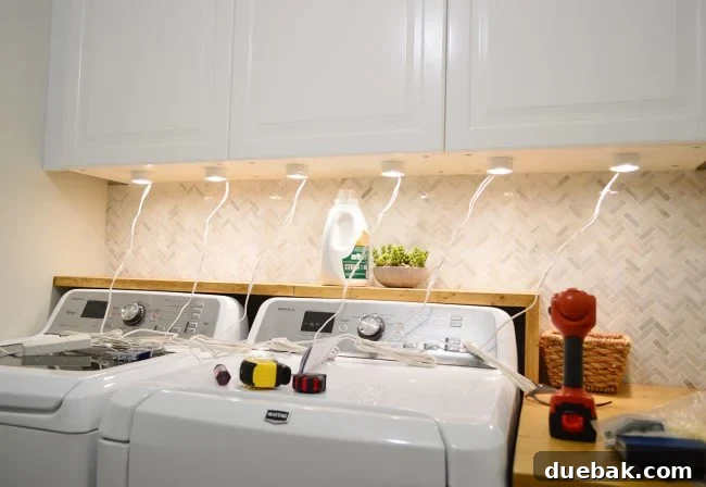 Elevate Your Kitchen Design with Under-Cabinet Lighting 8 The power cord of the under cabinet lighting transformer box is shown securely plugged into a standard electrical outlet.