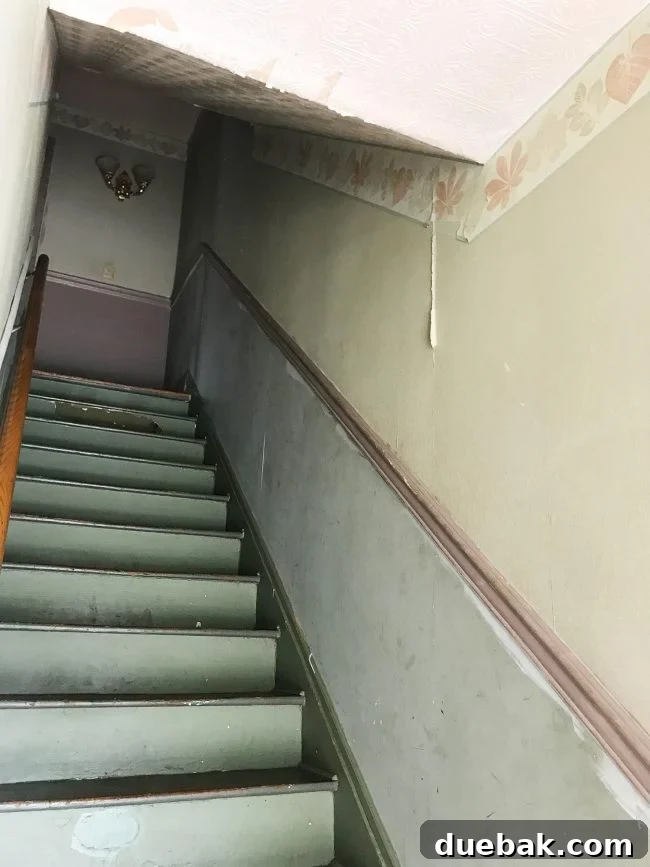 Duplex staircase before renovation with sloping ceiling