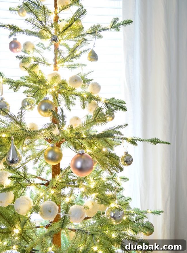 Double the Sparkle: Holiday Decorating at Home and the Beach 17 Close-up of a Christmas tree with repurposed pink and green ornaments.