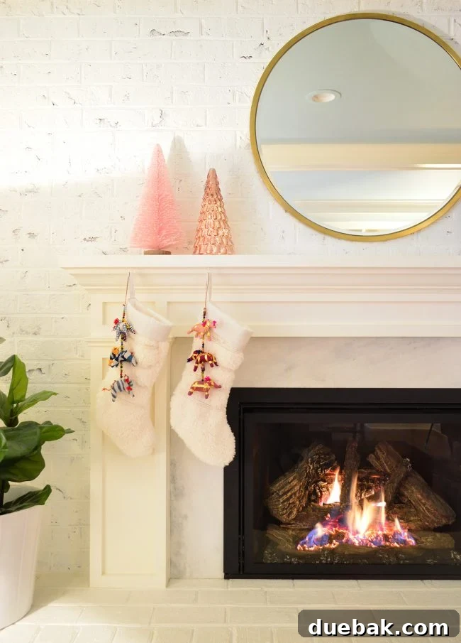 Double the Sparkle: Holiday Decorating at Home and the Beach 9 Christmas stockings hanging by the fireplace, decorated with small elephant chains.