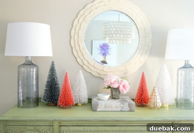 Double the Sparkle: Holiday Decorating at Home and the Beach 10 A dining room sideboard decorated with a collection of bottle brush trees.