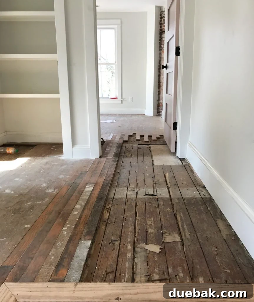 Reviving Oak and Pine Floors 12 Close-up view of the staggered integration technique used to seamlessly blend new and old floorboards during repair.