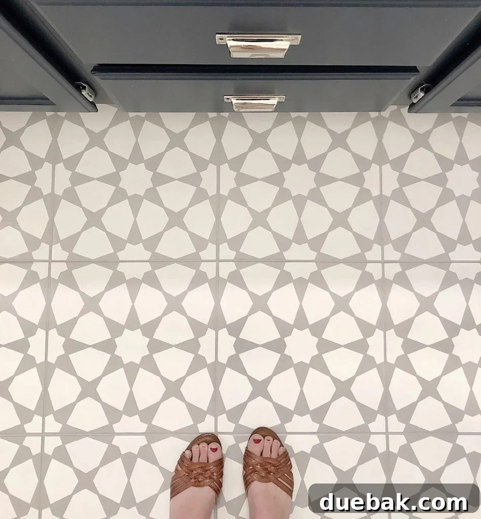 A beautifully stenciled bathroom floor tile, showcasing a dramatic and cost-effective makeover with paint.