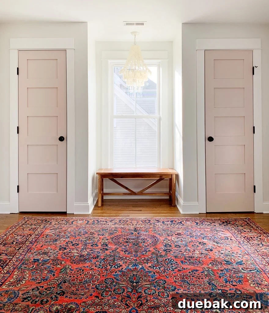 Renovated bedroom wall with bench, light fixture, and rug.