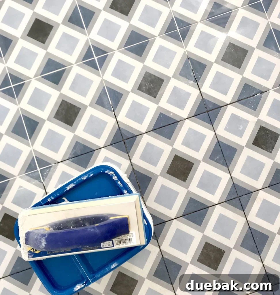 Finding Your Best Grout: Tips for Perfect Color Selection 13 blue diamond floor tile getting grouted with frost color mapei flexcolor