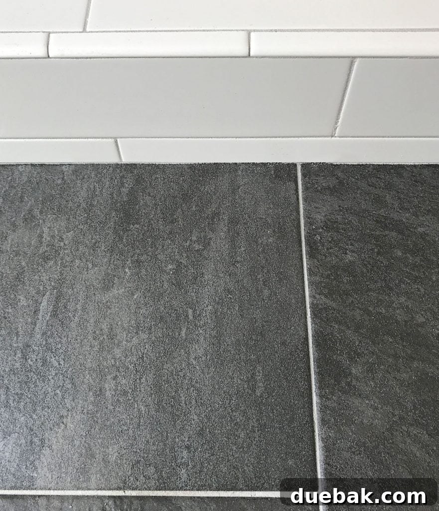 Finding Your Best Grout: Tips for Perfect Color Selection 10 white subway tile shower next to dark slate floor with same gray grout