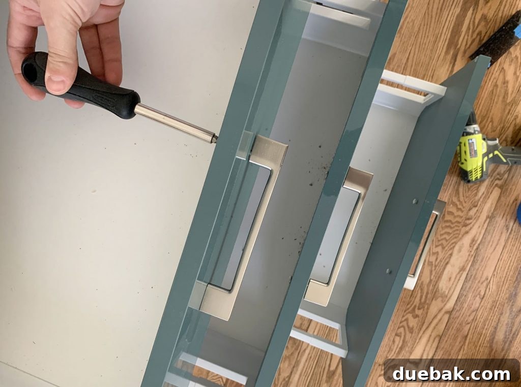 Tightening Hardware Screw With Philips Head Screwdriver for a finished and secure installation.