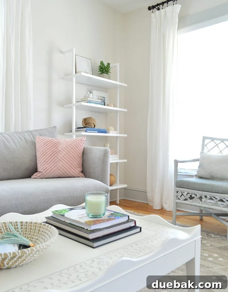 Close-up of the scalloped white coffee table, highlighting the inlay stenciled pattern on top and the rounded edges.