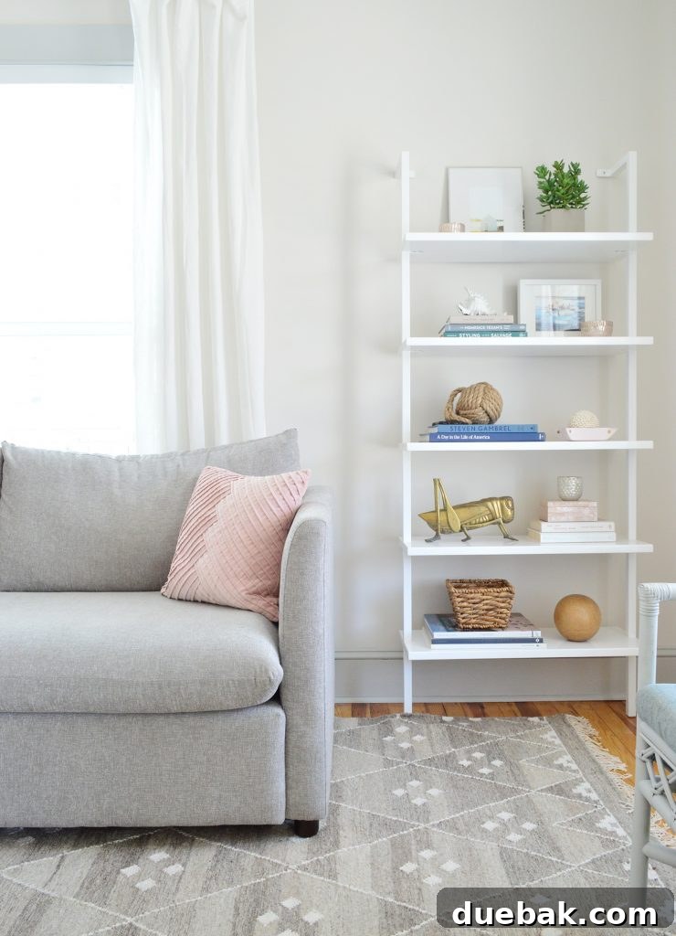 Close-up of beach house living room details, showing light walls and white furniture.