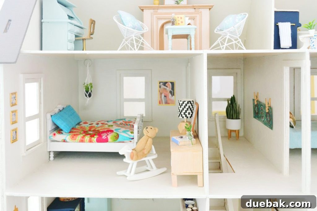 Wider view of the dollhouse bedroom with flamingo art, a hanging plant, and a stylishly reupholstered bed.