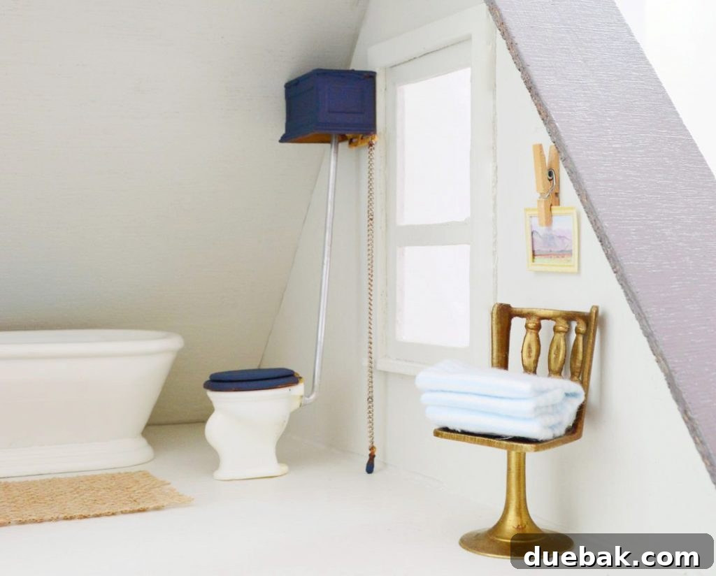 Close-up of the dollhouse toilet pull chain and DIY stacked towels on a miniature gold chair.