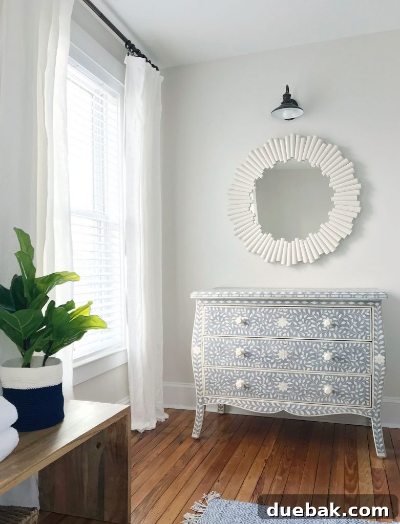 Sleep Sabotage: Are You Undermining Your Bedroom Bliss? 8 White faux wood blinds installed in a bright beach house bedroom, showcasing their clean design and light control.