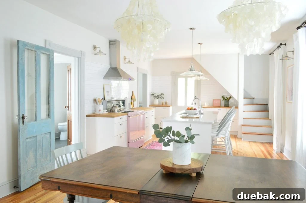 Beach house kitchen and dining room with faux greenery on table top