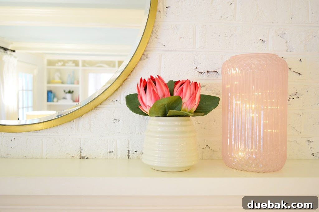 Faux flowers on fireplace mantle in living room