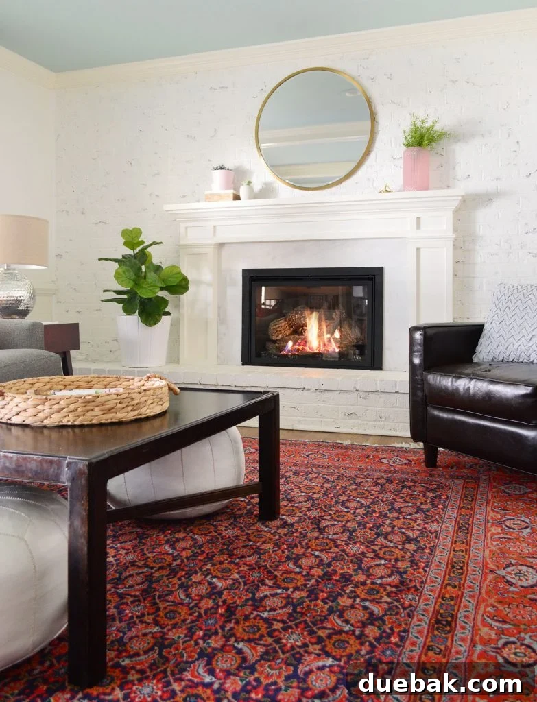 Faux greenery in living room with white walls and red vintage rug