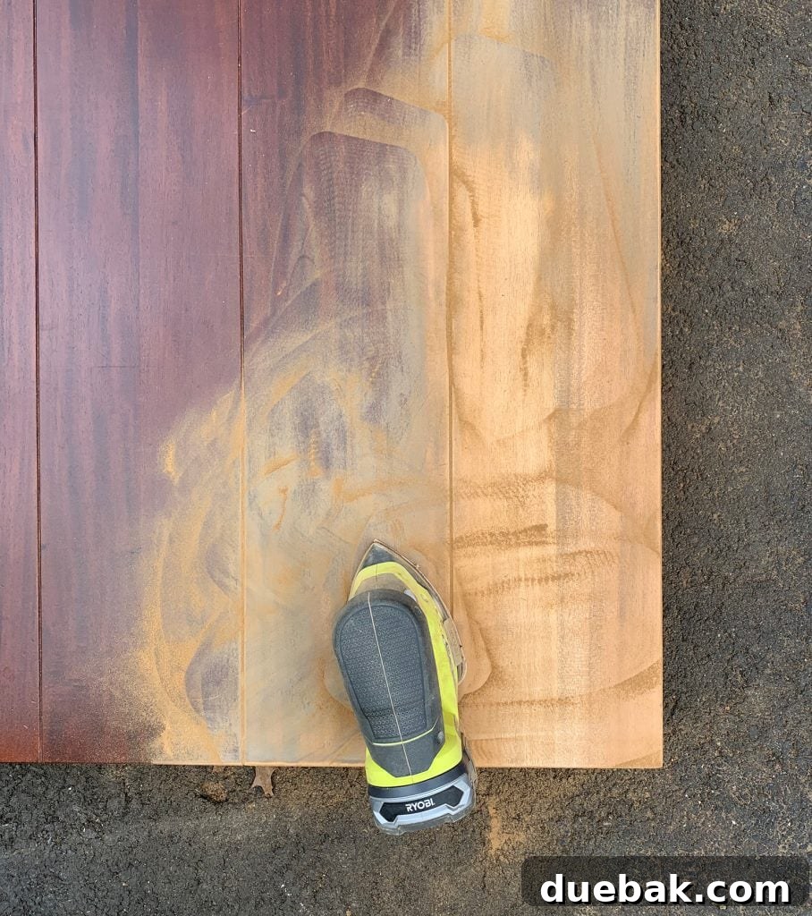 Give Your Table a Stunning New Life 2 Sanding the finish off of a wood dining table to refinish it with new stain