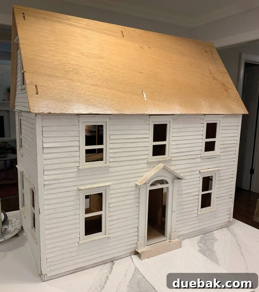 Dollhouse Overload: Finding the Tipping Point 2 A dollhouse before its makeover, showing a classic, slightly worn exterior.