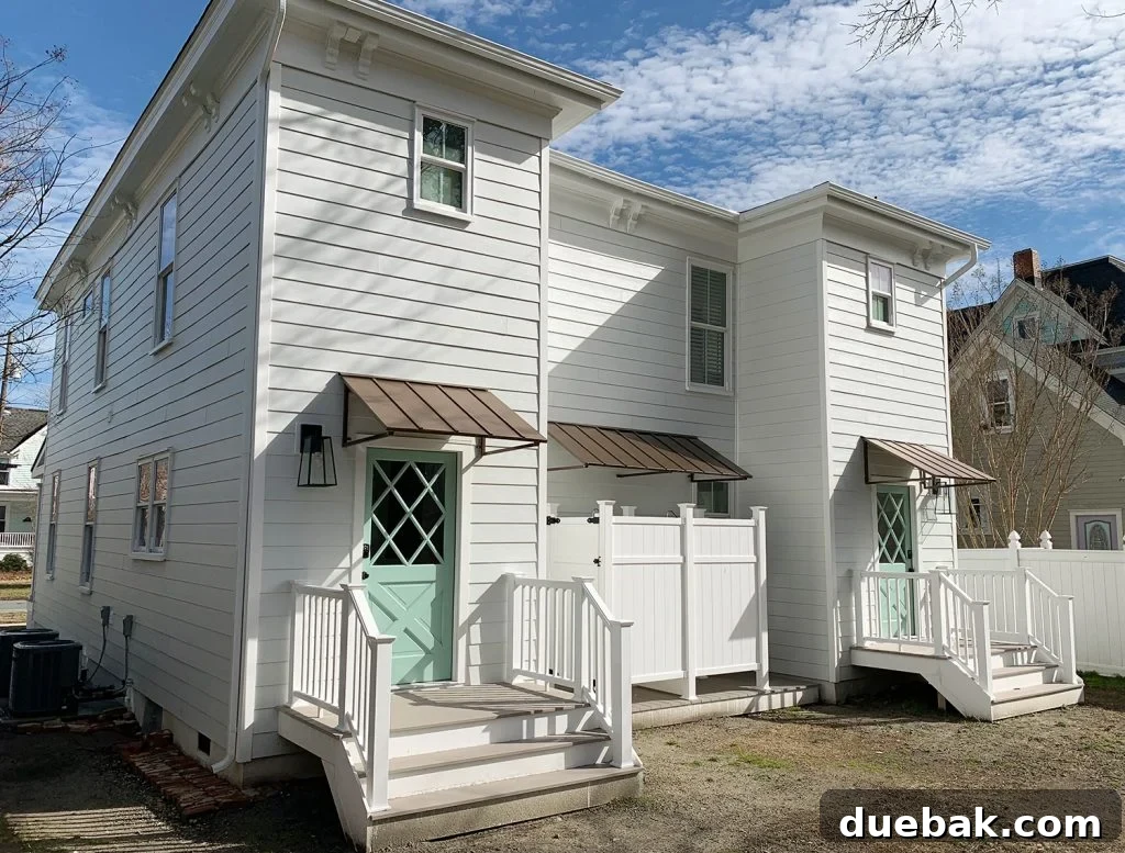 Transformed rear exterior of the duplex with new diamond doors, steps, and awnings