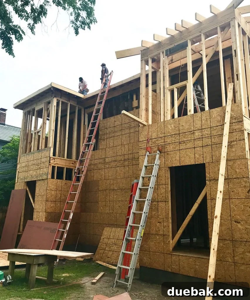 Side view of the duplex showing the new second-story bump-outs and structural improvements