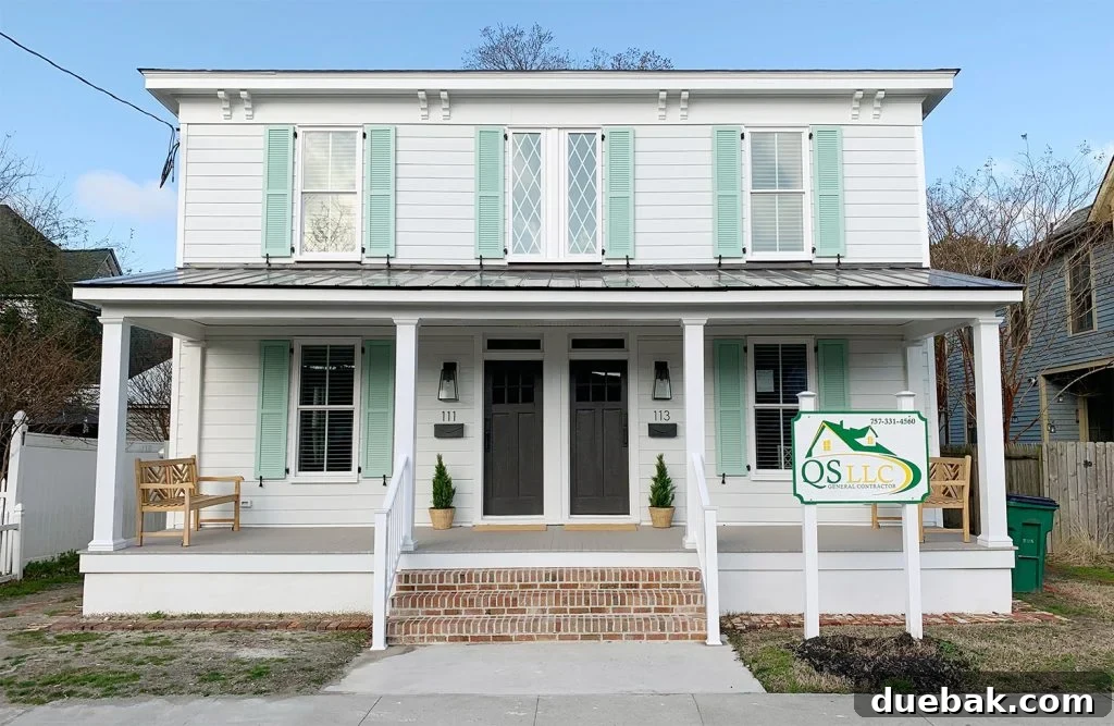 New back porch and steps of the duplex, featuring durable, low-maintenance materials and consistent lantern lighting