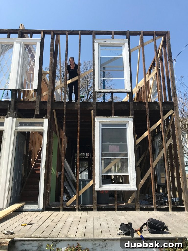 Our Airbnb Bedroom and Bathroom Makeover Full Reveal 14 Demolition phase of the duplex, showing stripped walls, exposed structural elements, and a glimpse into the raw renovation process.