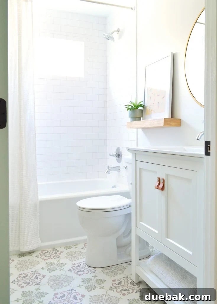 Our Airbnb Bedroom and Bathroom Makeover Full Reveal 20 Comparison of two hall bathrooms, highlighting distinct floor tile patterns while maintaining consistent fixtures and vanity style.