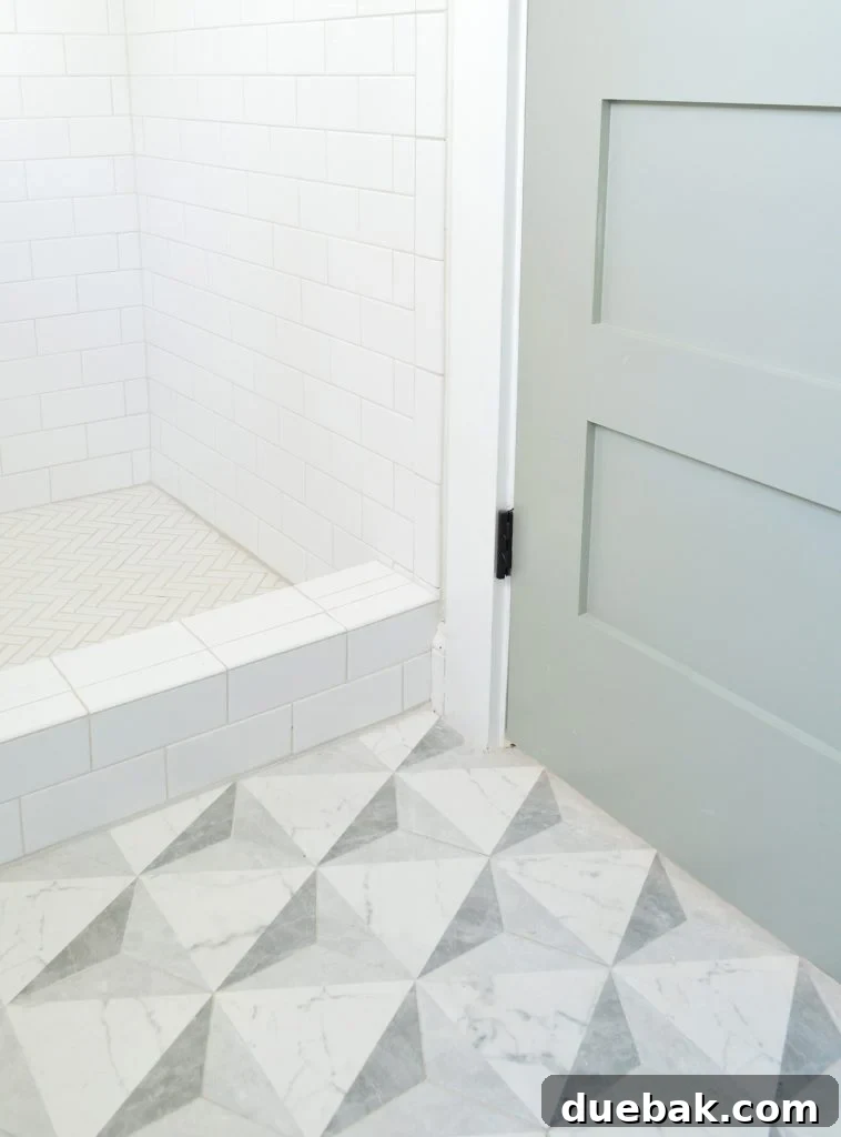 Our Airbnb Bedroom and Bathroom Makeover Full Reveal 6 Detail shot of bathroom floor tile and shower wall tile in a cohesive and modern design.