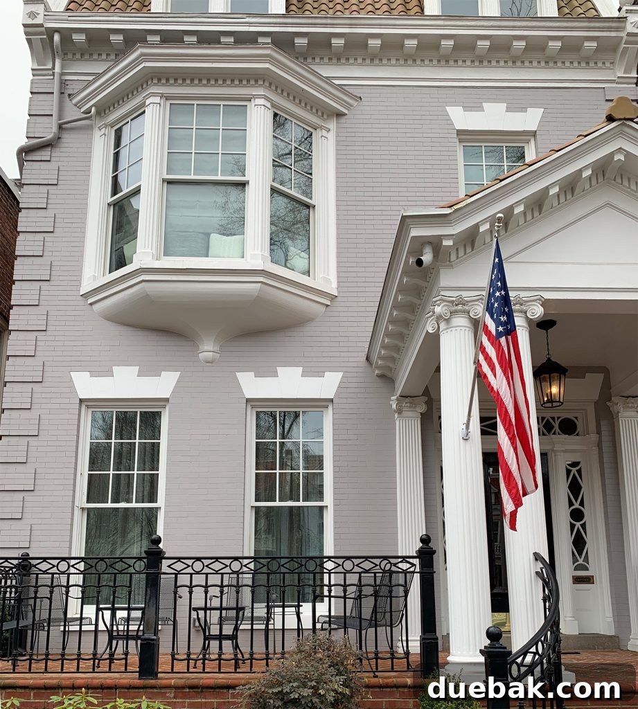 Close-up of a white painted brick house exterior with elegant details