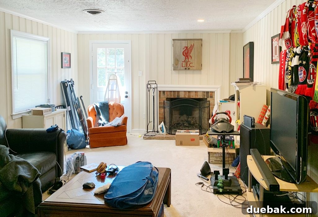 Before photo of a cluttered basement gaming room before home staging, highlighting the transformation.