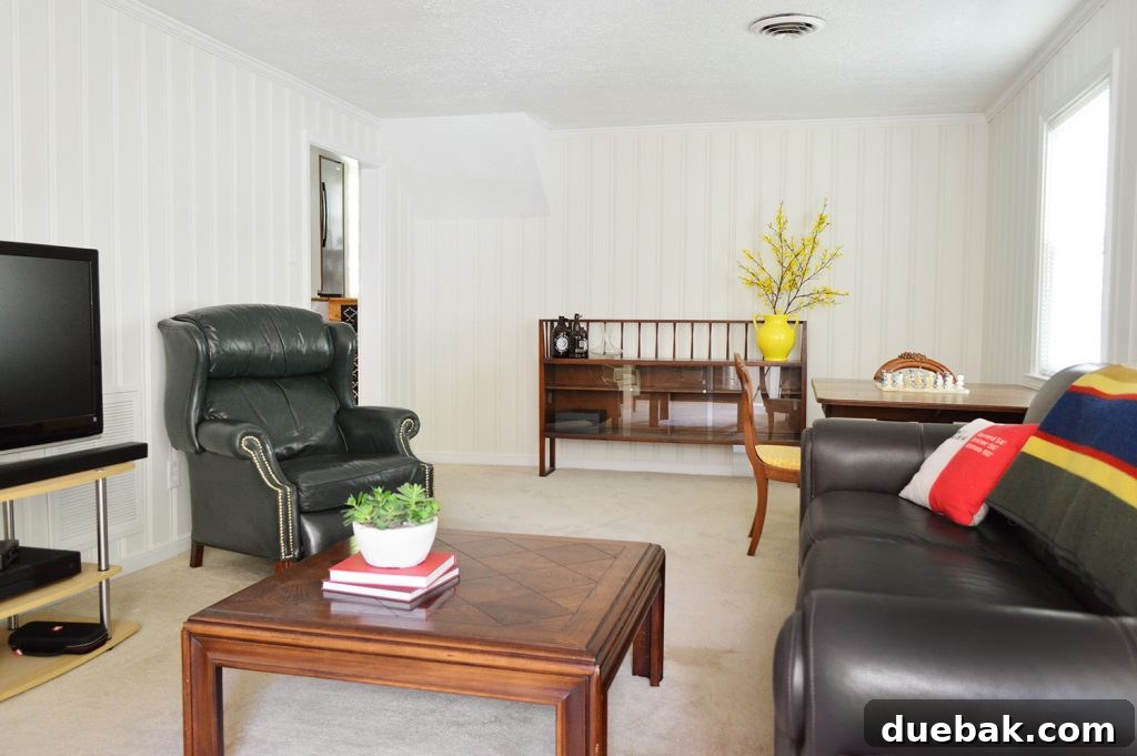 After photo of the staged basement living space, showing a minimalist and elegant design.