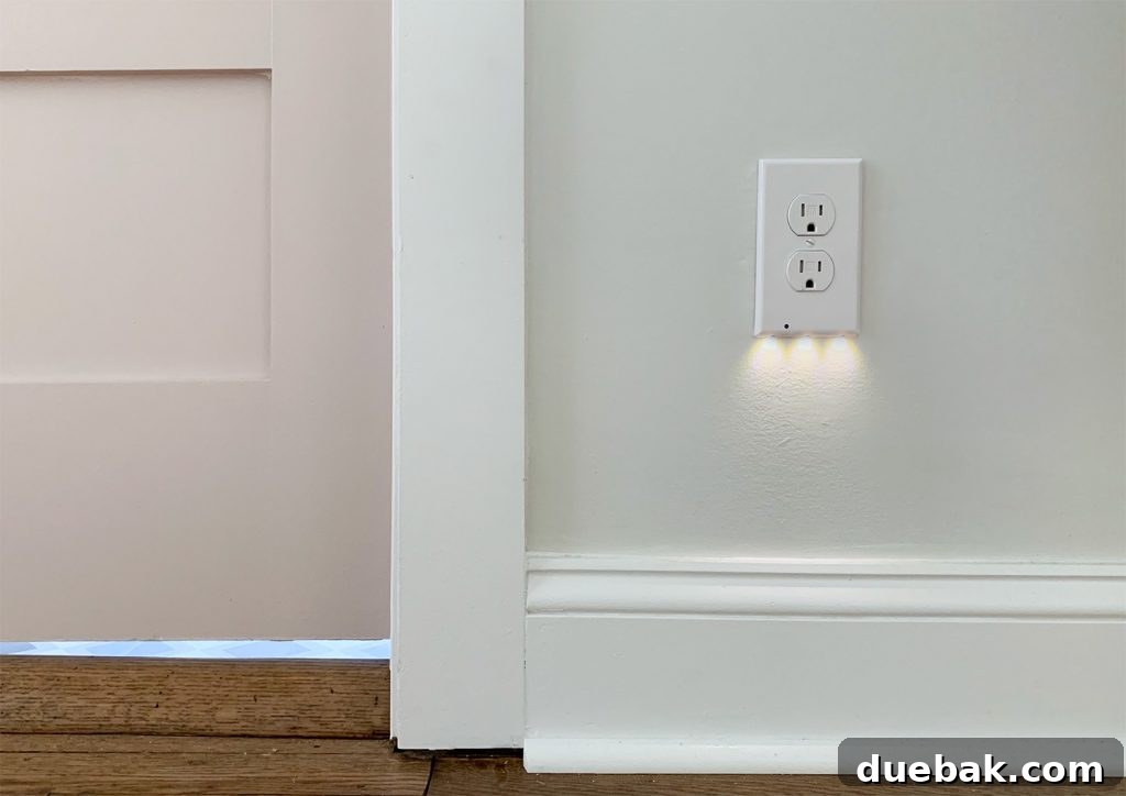 SnapPower nightlight installed in an electrical outlet, providing subtle illumination in a hallway.