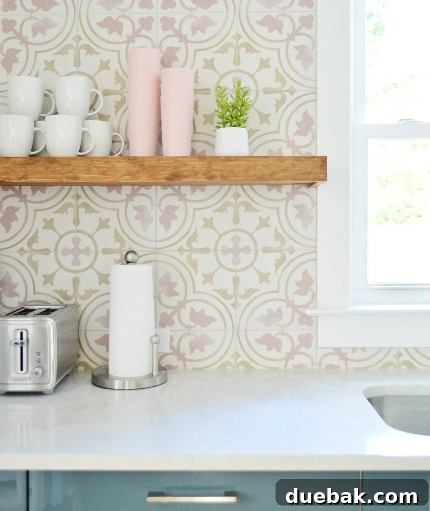 Dual Kitchen Transformations: Our Airbnb's Story 16 Floating shelves displaying mugs and decor above pink tile backsplash in a blue Ikea kitchen.
