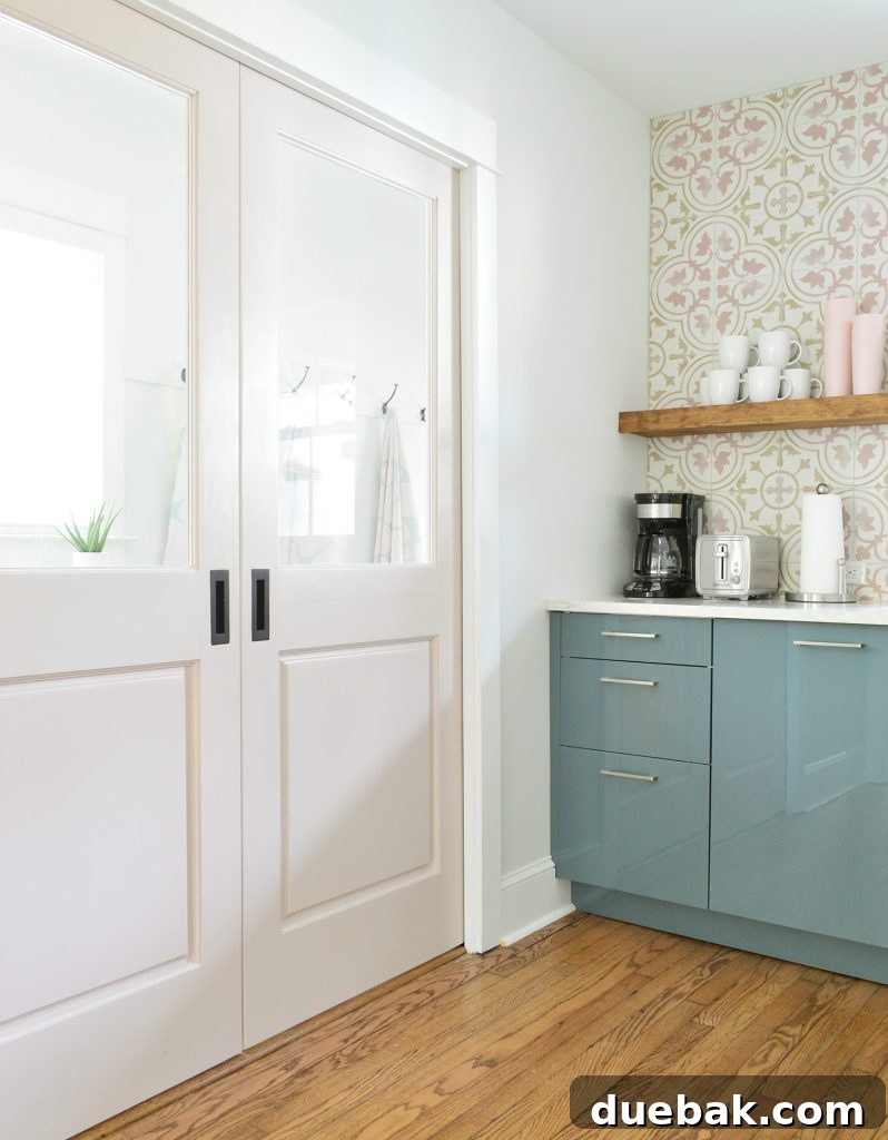 Dual Kitchen Transformations: Our Airbnb's Story 17 Pink pocket doors separating the duplex kitchen from the mudroom, showcasing the coordinated color palette.