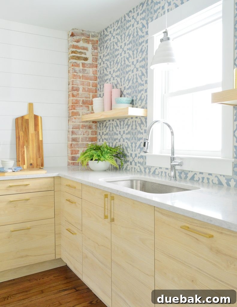 Dual Kitchen Transformations: Our Airbnb's Story 24 Duplex kitchen with a blue tile backsplash and open wood shelves, featuring a sleek exhaust hood.