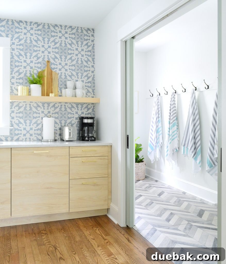 Dual Kitchen Transformations: Our Airbnb's Story 27 Duplex mudroom seen through kitchen pocket doors, showing coordinated design and functionality.