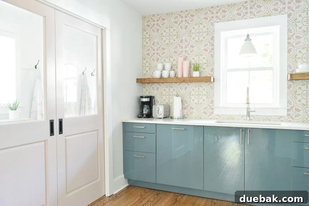 Dual Kitchen Transformations: Our Airbnb's Story 8 View into a pink mudroom from a blue kitchen, with pocket doors closed, showcasing a clean and organized space.