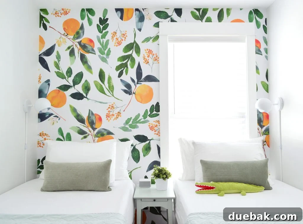 Small, inviting room featuring an orange blossom wall mural, twin bed, and practical sconces.